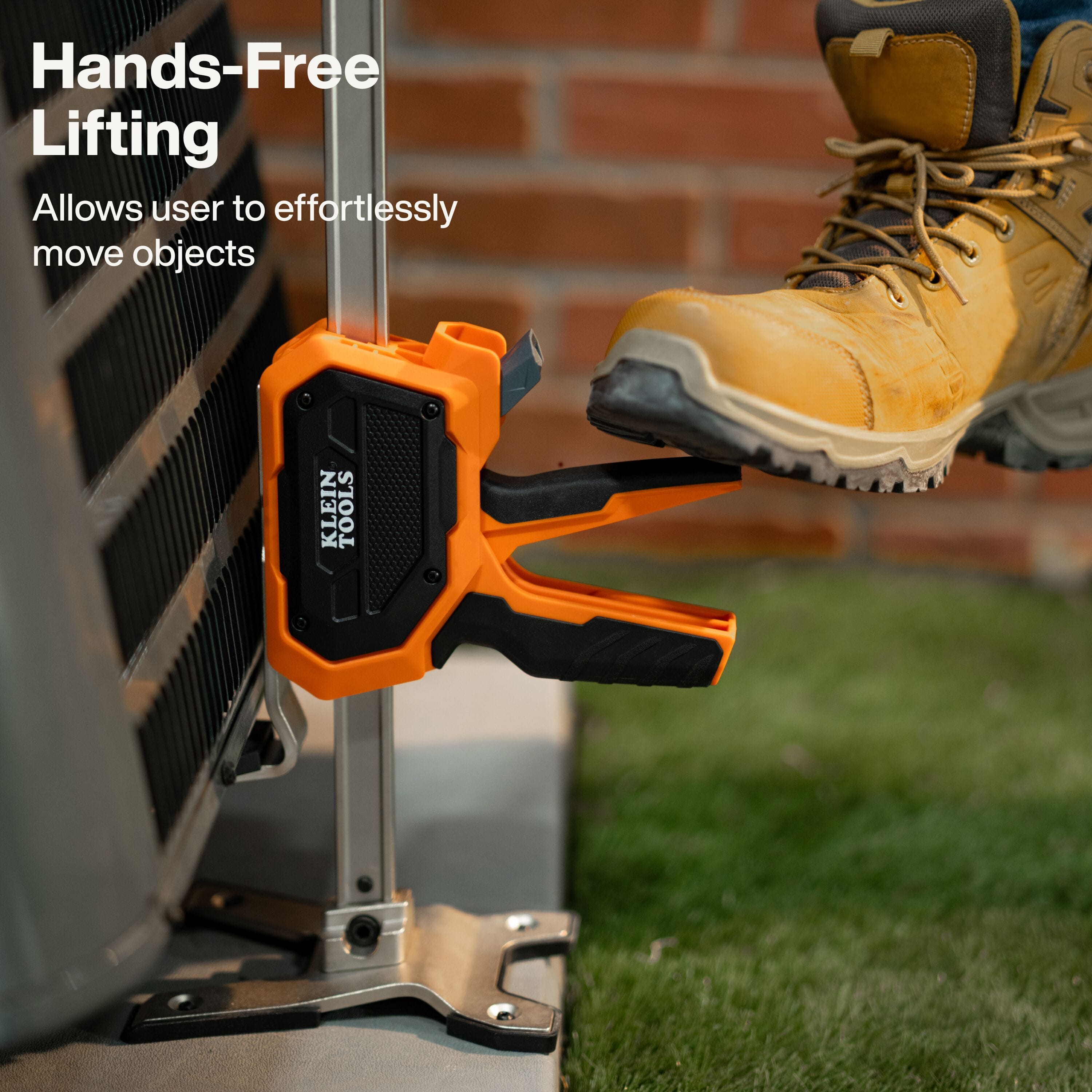 An application photo demonstrating hands-free lifting, where a professional contractor uses their foot to engage the lift lever on an HVAC unit, allowing for precise positioning and effortless movement of heavy objects.