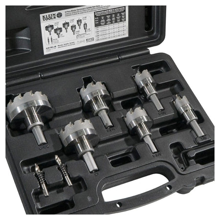 The open Klein 8-piece carbide hole cutter kit, showing all six cutters and two extra pilot bits organized in their molded spots.
