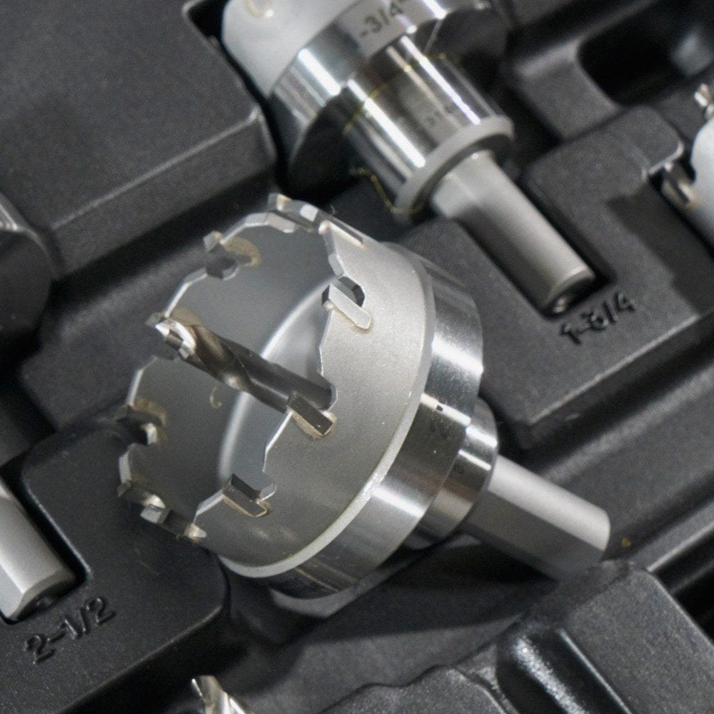 A close-up of one of the carbide hole cutters resting in its molded position within the black carrying case.