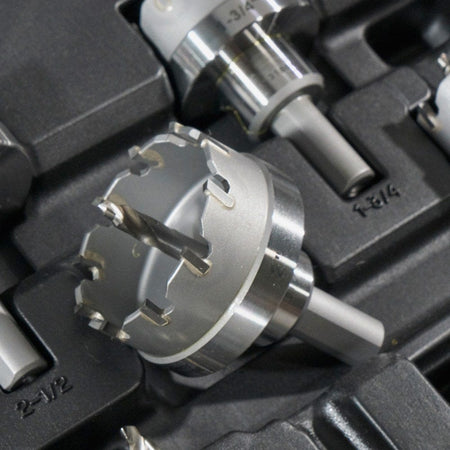 A close-up of one of the carbide hole cutters resting in its molded position within the black carrying case.
