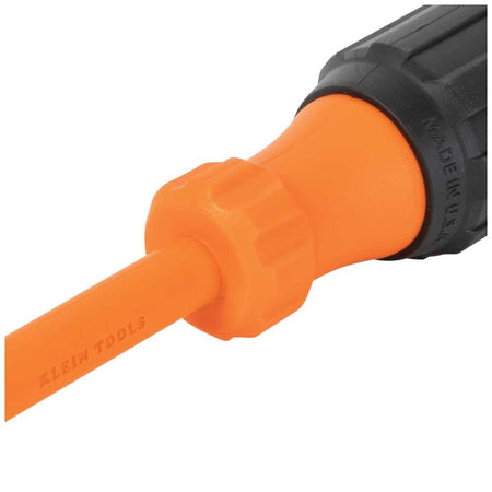 Klein Tools industrial-grade insulated hand screwdriver shaft transition zone detail view, illustrating the seamless injection-molded union between the smooth bright orange protective dielectric layer and a fluted orange high-dielectric handle bolster component clearly stamped with a Made in USA quality marking.