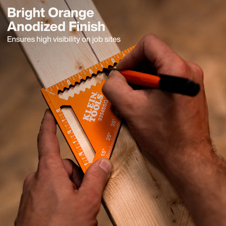 An action shot showing a professional carpenter using the Klein Tools orange anodized square to scribe a precise line on a lumber board, demonstrating the tool's high visibility and accuracy in woodworking applications.