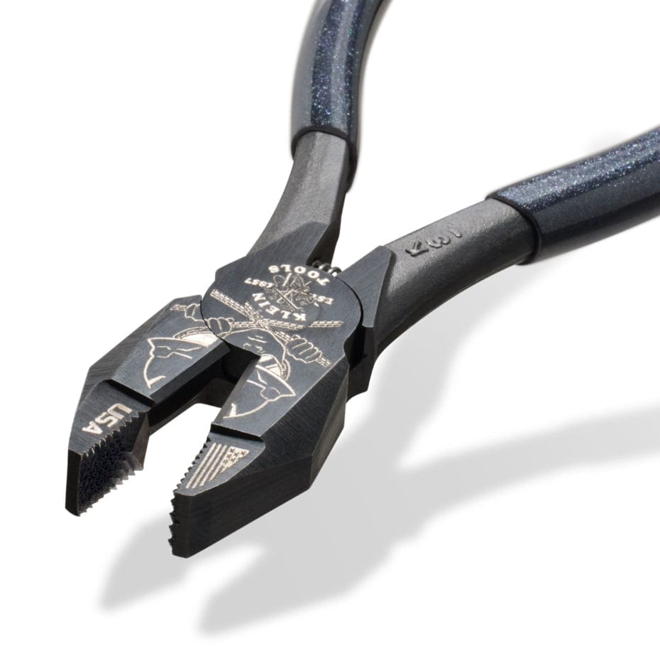 High-leverage Klein Tools side-cutting pliers with dark blue grips and engraved head showing lineman artwork, USA origin
