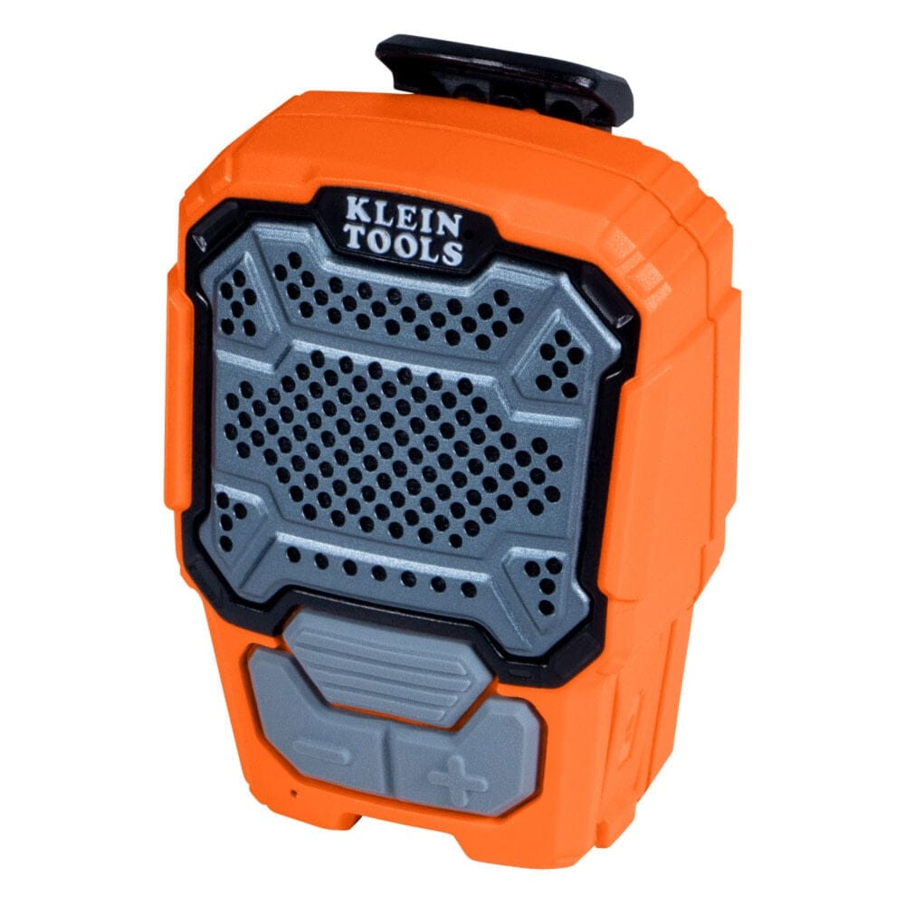 Studio view of the compact orange wearable speaker featuring a grey perforated grille, Klein Tools logo, and large rubberized control buttons.