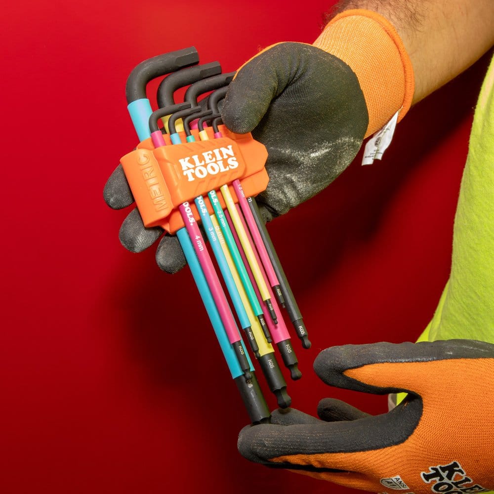 Metric hex key set in a high-visibility orange caddy being held by a user, showcasing the various color-coded sleeves for rapid size identification on the job.