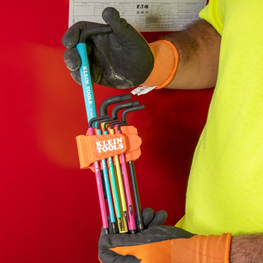 Technician removing a 10 mm metric ball end allen wrench from the orange storage caddy, demonstrating the quick-access design of the color-coded hex key set.