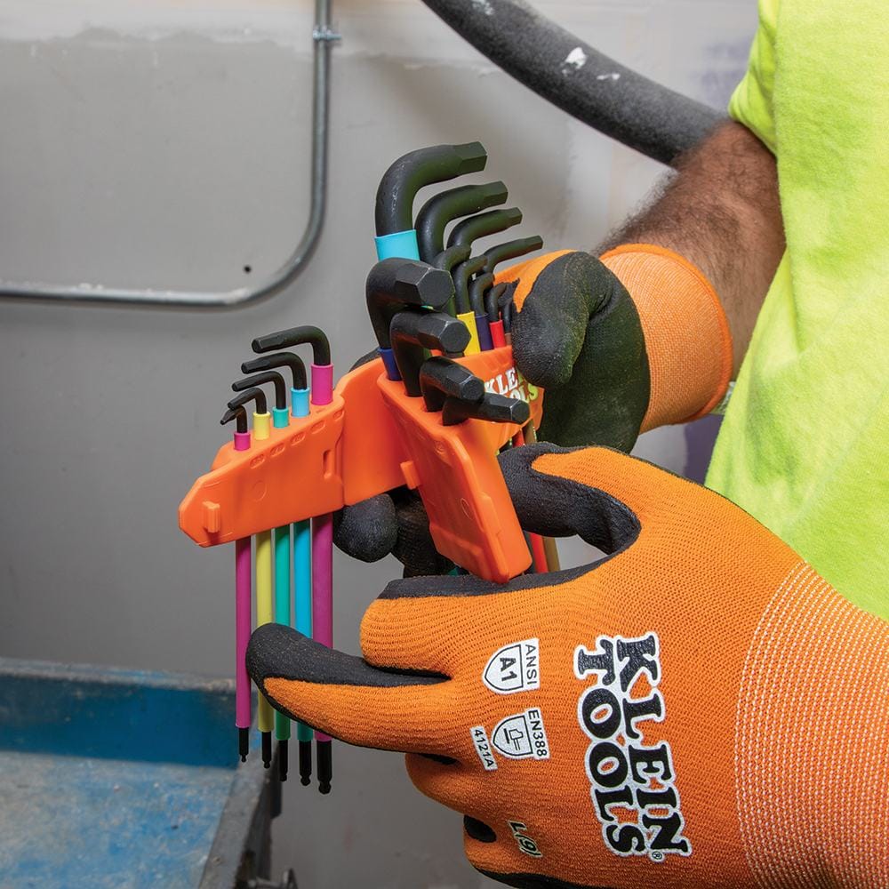 Technician demonstrating the interlocking feature of the Klein Tools SAE and metric hex key caddies, which allows for organized and sleek tool storage.