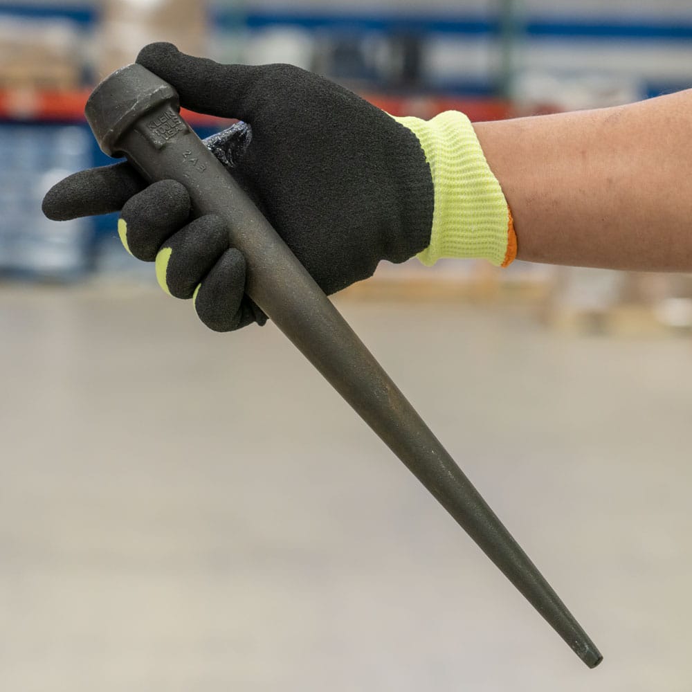 Gloved hand holding the Klein 3255 broad-head bull pin to showcase its ergonomic balance and 13.75-inch overall length.