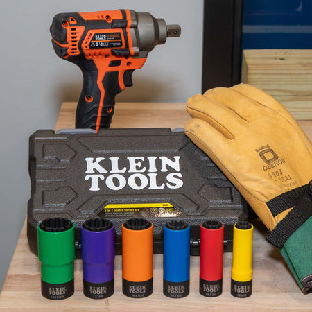 Klein 66033 6-piece coated socket kit arranged on a workbench beside a 1/2-inch power impact wrench and leather utility gloves.