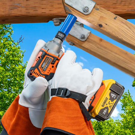 Lineman in high-voltage gloves using a blue 3/4 x 9/16-inch coated impact socket on a power tool to fasten overhead wooden cross-arm bolts.