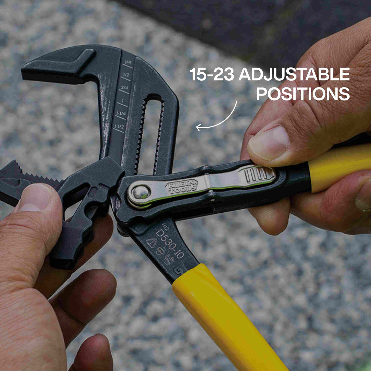 Hands adjusting a Klein Tools 10-inch plier wrench to demonstrate the 15 to 23 adjustable positions available, showcasing the versatility and wide capacity of the tool for different fastener sizes.