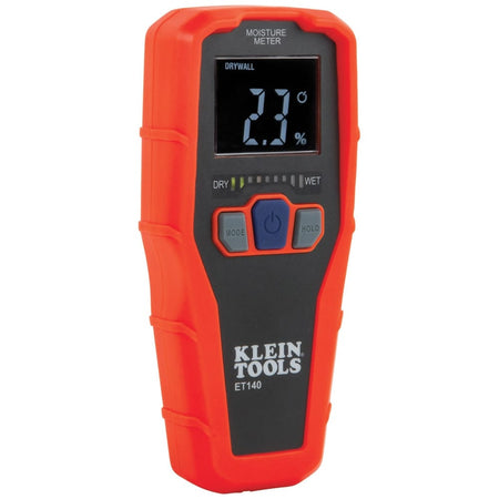 A studio shot of the Klein Tools ET140 Pinless Moisture Meter against a white background. The device features a bright orange housing with a black faceplate, a digital LCD screen showing a 2.3 percent moisture reading, and three buttons for mode selection, power, and data hold.