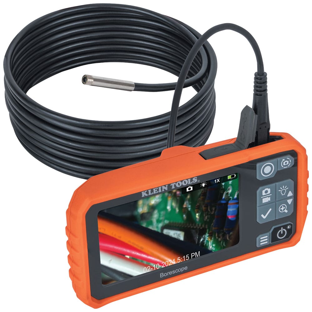 A complete assembly view of the Klein Tools ET17 Utility Borescope. The handheld monitor is shown displaying a live 720p color image of electrical components, connected to the coiled 10-foot high-reach camera probe designed for deep system inspections.
