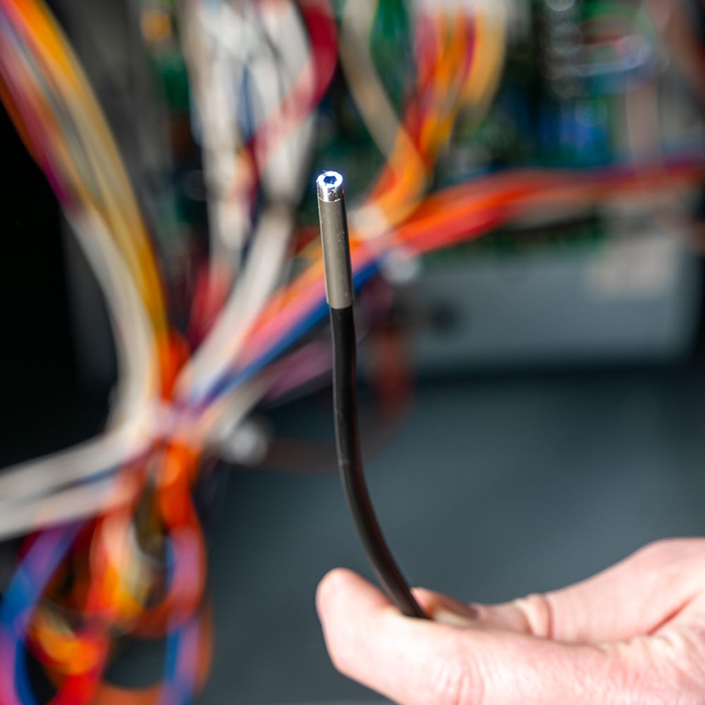 Close-up of the ET17 5.5mm camera head with its 6 integrated LEDs fully illuminated. The bright, adjustable light output is shown providing high-intensity illumination for the waterproof (IP67) sensor, essential for viewing dark, confined spaces in plumbing and mechanical systems.