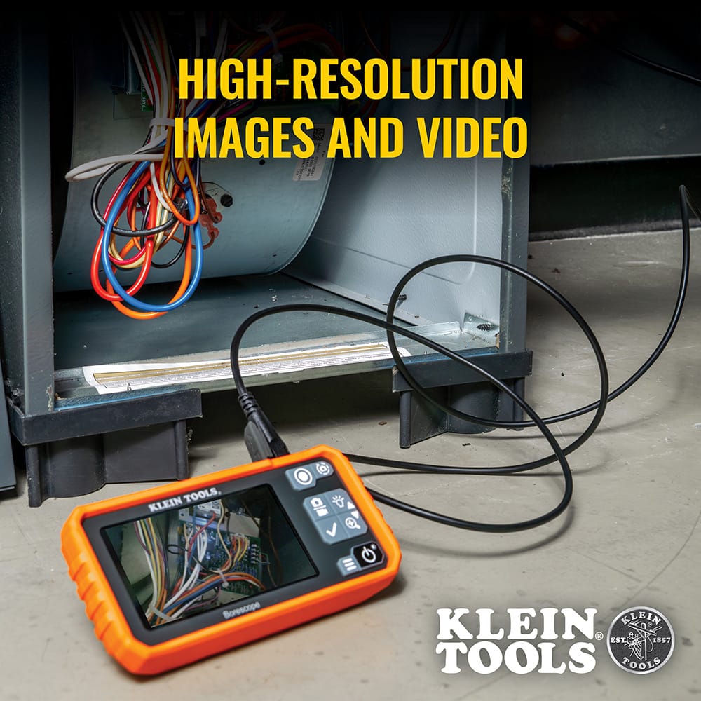 Action shot of the ET17 utility borescope being used to inspect the internal components of an HVAC furnace cabinet. The high-resolution 4.3-inch color screen displays a clear view of the wiring and circuit boards, demonstrating its effectiveness for professional mechanical diagnostics.