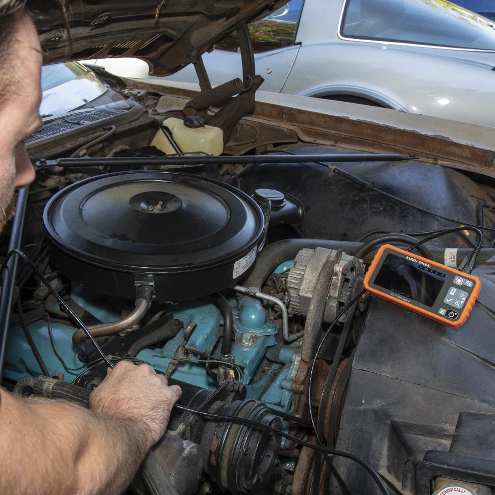 Rear perspective view of the ET19 Pro borescope with the integrated kickstand fully deployed. The stand allows the technician to set the monitor on a flat surface for hands-free viewing while navigating the 10-foot armored camera probe through conduits or engine blocks.