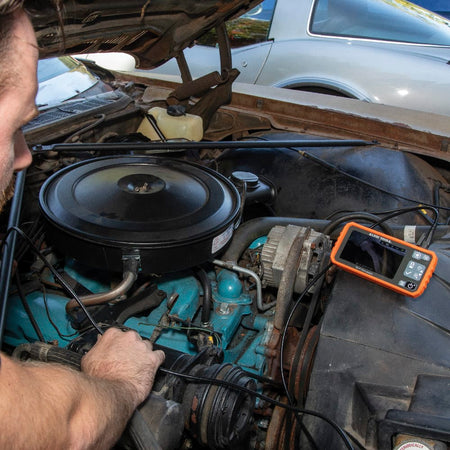 Rear perspective view of the ET19 Pro borescope with the integrated kickstand fully deployed. The stand allows the technician to set the monitor on a flat surface for hands-free viewing while navigating the 10-foot armored camera probe through conduits or engine blocks.
