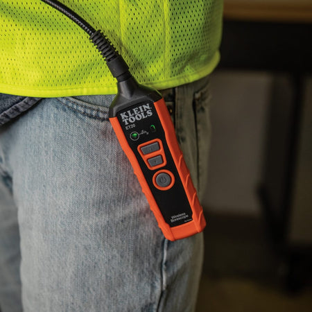 A lifestyle shot of the ET20 borescope transmitter secured to a technician's pocket using the integrated clip. The green WiFi indicator is illuminated, showing the device is active and ready to transmit high-definition inspection data to a nearby smartphone or tablet.