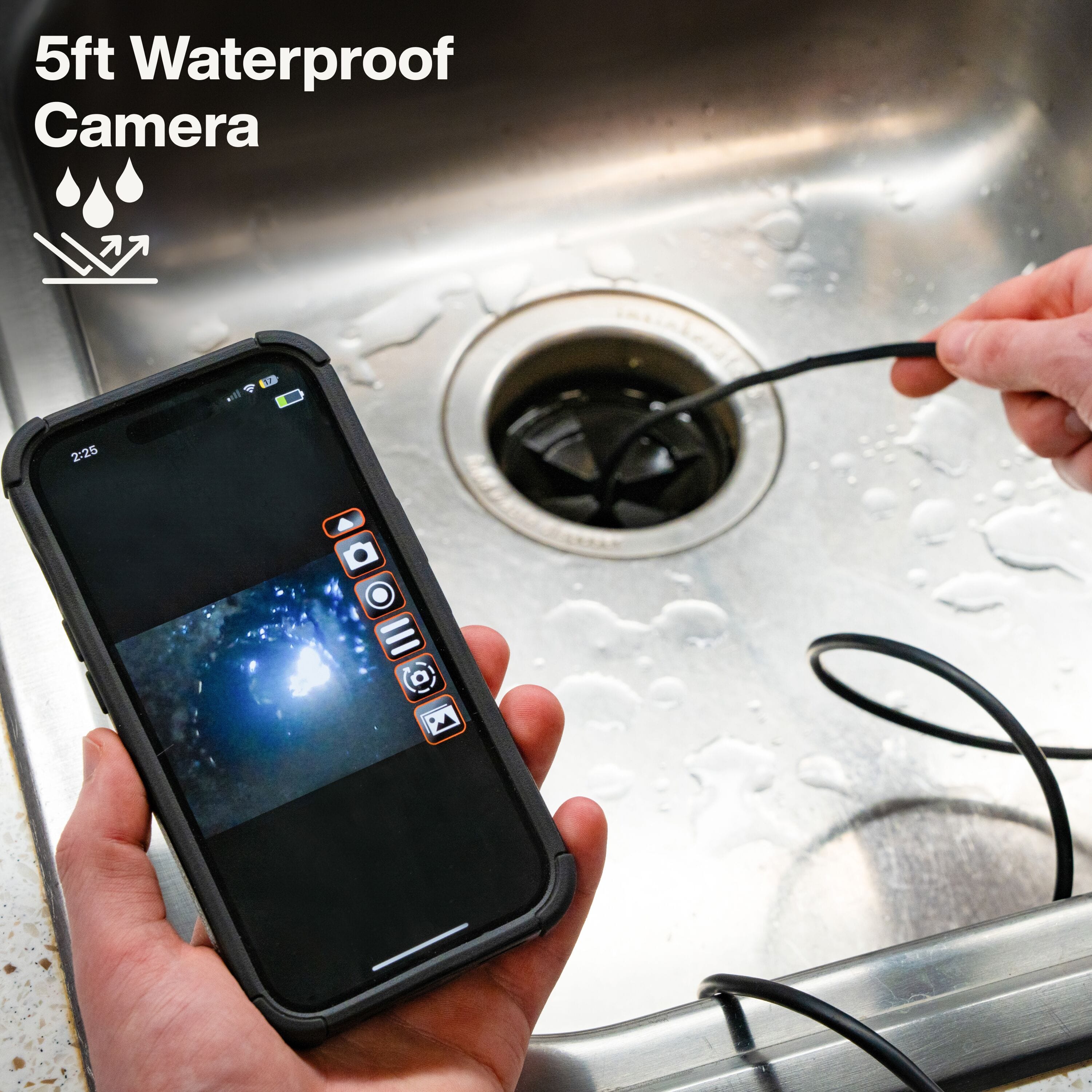 Action shot of a technician using the 5-foot waterproof camera to inspect a kitchen sink drain, with the live video feed displayed simultaneously on a smartphone screen.