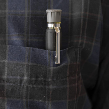 Klein 32614 precision driver clipped into a shirt pocket with its tip fully concealed by the sliding collar to prevent fabric tears.