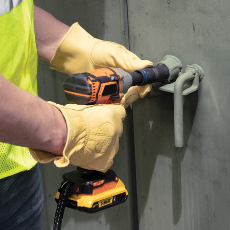 Utility technician using the 13/16-inch penta end of a Klein 66080 flip socket on a 1/2-inch impact wrench to open a transformer door latch bolt.