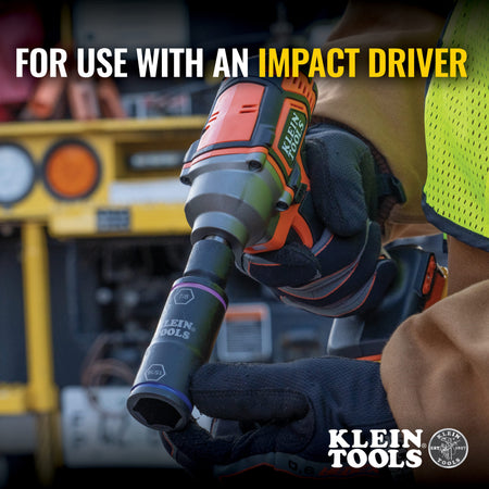 Electrician holding a 1/4-inch impact driver fitted with a 7/8 by 15/16-inch Klein flip socket to demonstrate overhead fastening.
