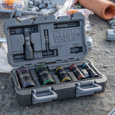 Klein 66070 7-piece flip socket set resting in its molded storage case on a concrete jobsite floor.