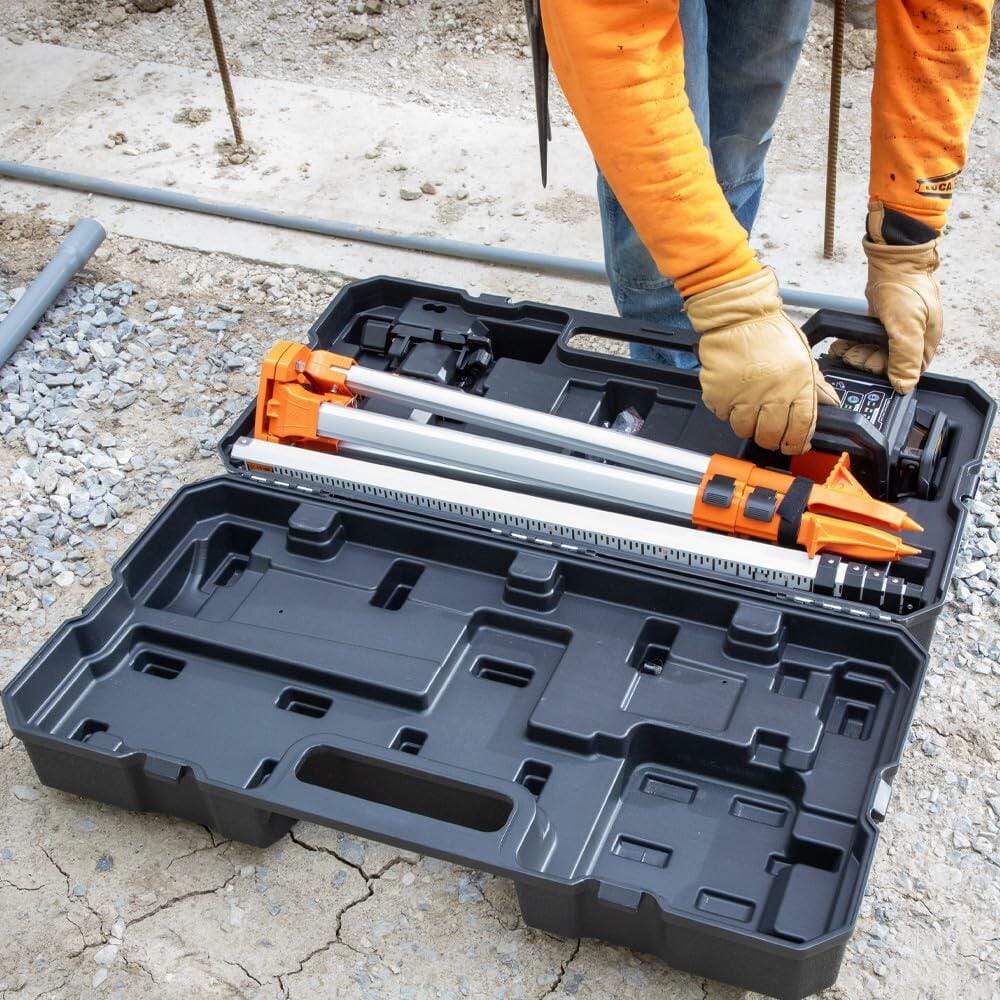 Person wearing gloves handling a leveling rod and optical level stored in a hard case, preparing surveying equipment at a construction site.