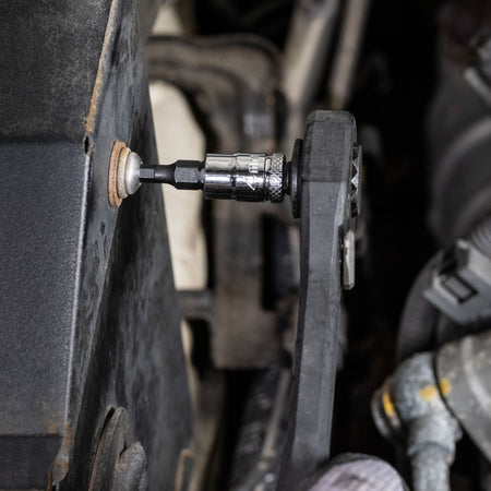 Mechanic using a pass-through ratchet and Klein 4 mm knurled hex bit socket to turn a recessed set bolt in an engine compartment.