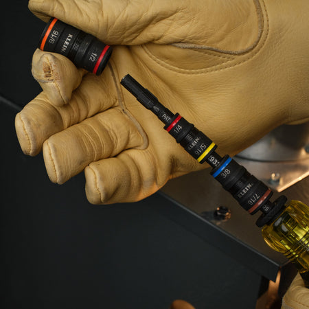 Technician removing the 1/2 and 9/16-inch flip socket to access the 1/4-inch bit-holding drive on the Klein 32303HD multi-bit shaft.