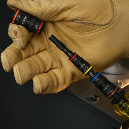 Technician removing the 1/2 and 9/16-inch flip socket from the Klein extension shaft to quickly access the 1/4-inch bit-holding drive end.