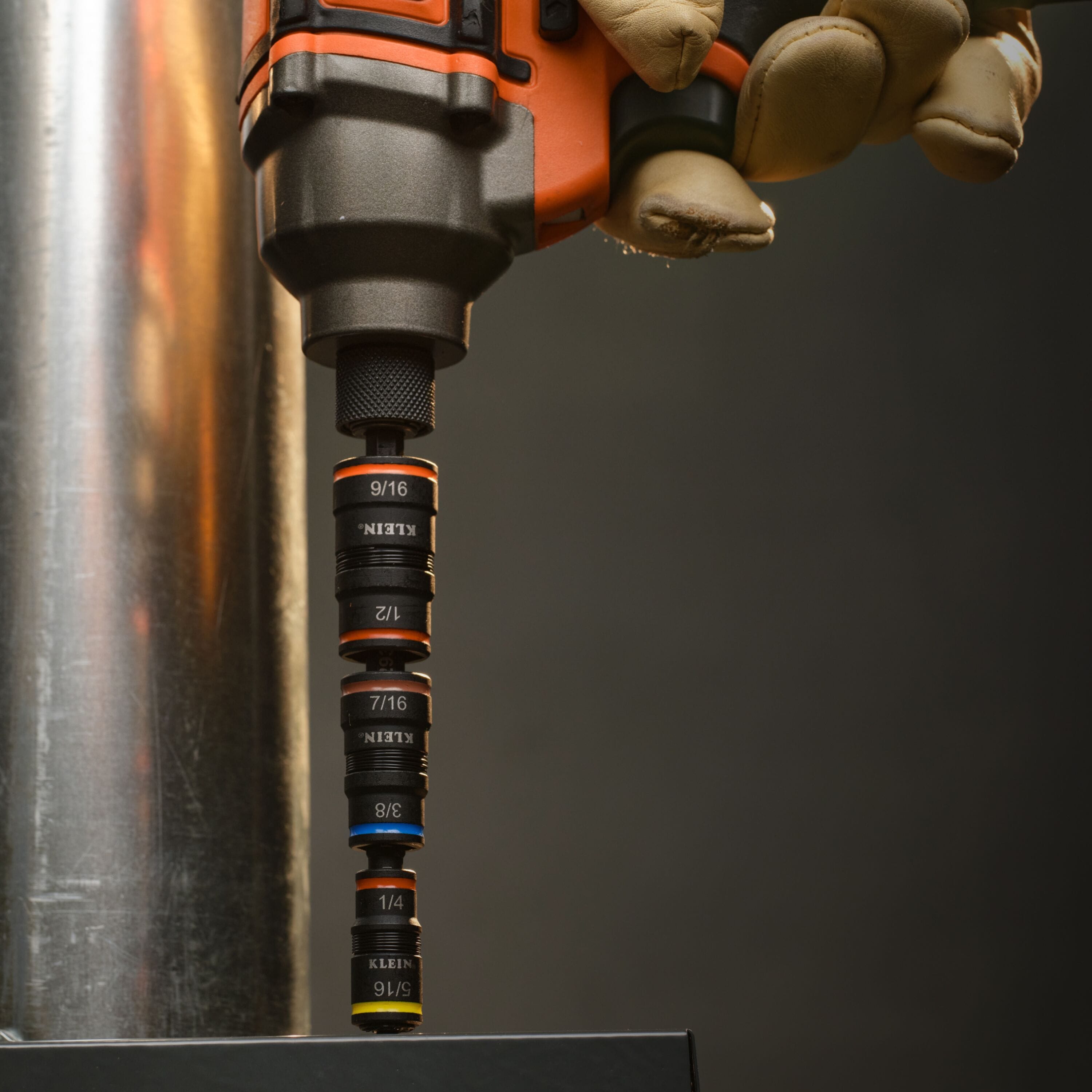 Technician driving sheet metal screws on an HVAC duct using the Klein 32910RCHT flip socket extension set mounted in a power impact driver.