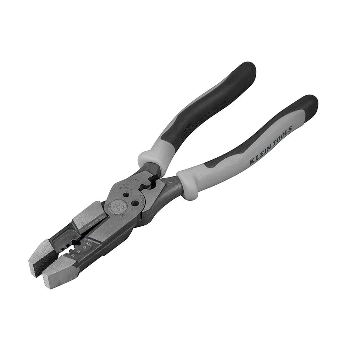 An open, angled overhead product shot of the heavy-duty high-leverage hybrid pliers resting on a white surface, showcasing the detailed multi-zone cutting, wire stripping, and crimping jaws alongside the dual-tone gray and black Journeyman comfort handle handles.