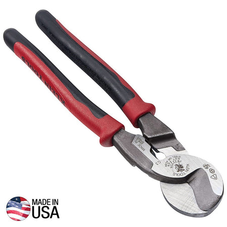 A high-leverage product shot of the Klein Tools J63225N Journeyman cable cutter featuring red and black dual-material handles and a forged steel head with a Made in USA emblem, designed for cutting large diameter aluminum and copper cable.