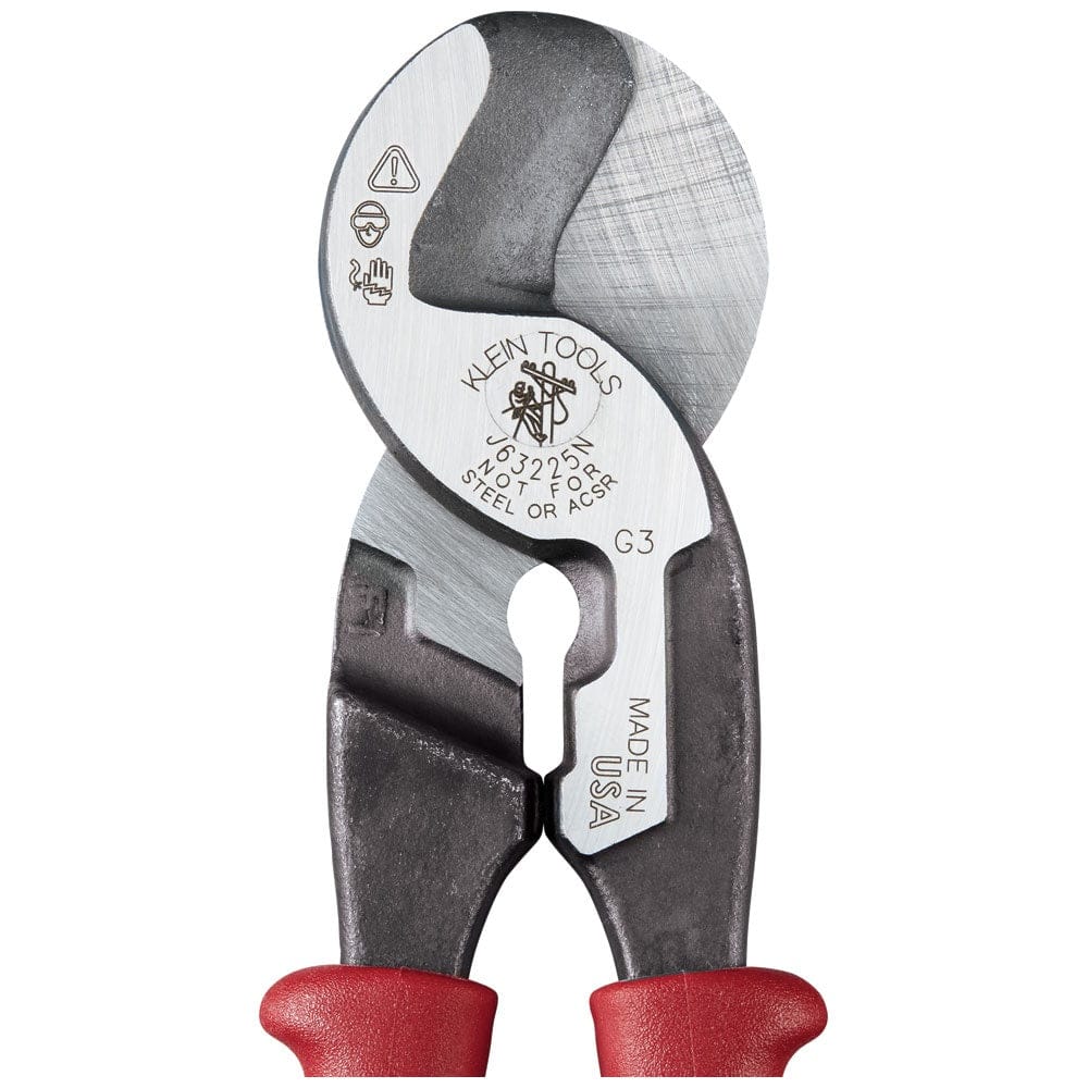A close-up view of the forged steel head of the Klein J63225N cable cutter, displaying the laser-etched model information, "Not for Steel or ACSR" warning, and the integrated stripping hole for 1/0 and 2/0 cable.