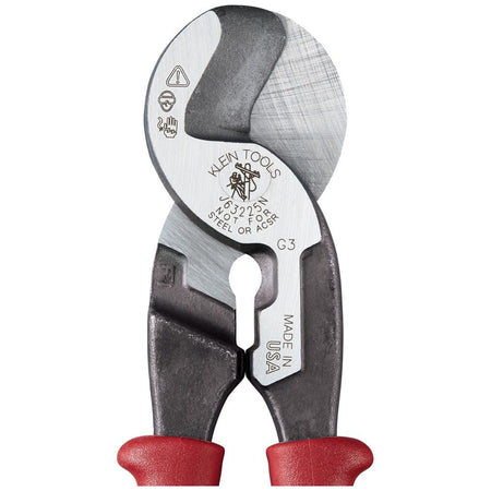 A close-up view of the forged steel head of the Klein J63225N cable cutter, displaying the laser-etched model information, "Not for Steel or ACSR" warning, and the integrated stripping hole for 1/0 and 2/0 cable.