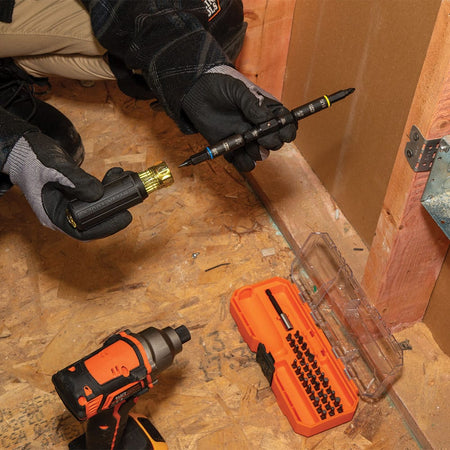 Electrician detaching the 32501HD KNECT double-ended shaft from a Cushion-Grip handle to switch rapidly between manual and impact power driving.