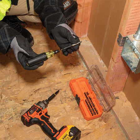 Contractor inserting the 32501HD magnetic 1/4-inch bit holder into a Cushion-Grip handle near an electrical junction box and impact driver.
