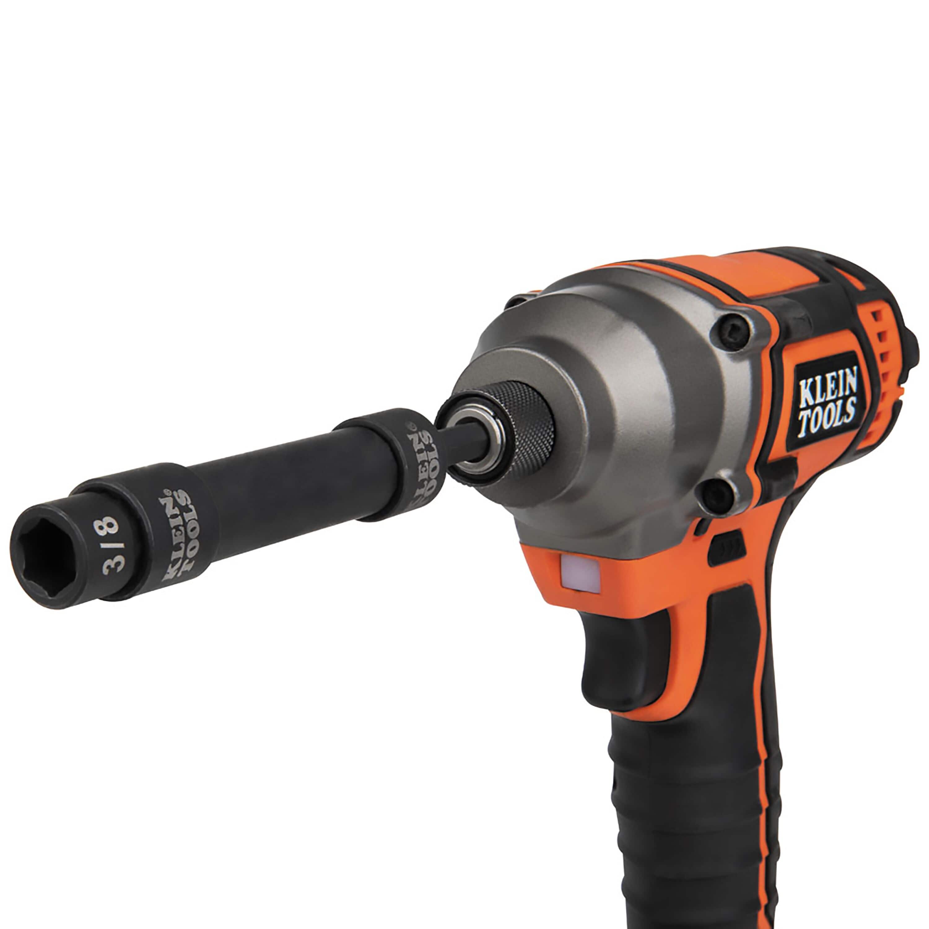 Klein Tools 1/4-inch cordless impact driver fitted with an impact adapter, extension bar, and 3/8-inch pass-through socket.
