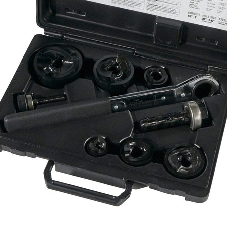 The Klein knockout punch set laid out inside its open black carrying case, showing all punches, dies, studs, and the wrench in their molded spots.