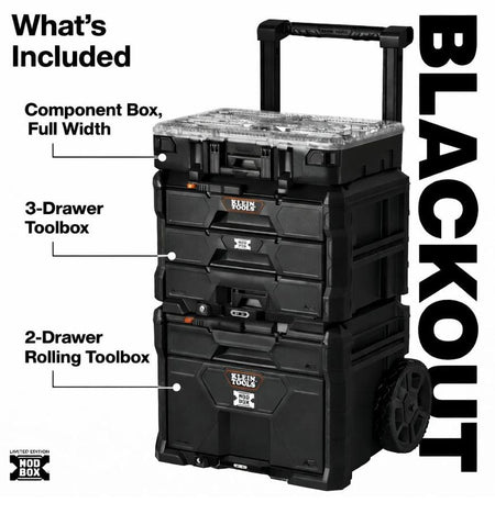 A front studio view of the Klein Tools Limited Edition MODbox Blackout 3-Piece set. The stack includes a 2-drawer rolling toolbox base with heavy-duty wheels and a telescoping handle, a 3-drawer toolbox in the middle, and a full-width component storage box on top, all featuring a sleek professional black-on-black finish.