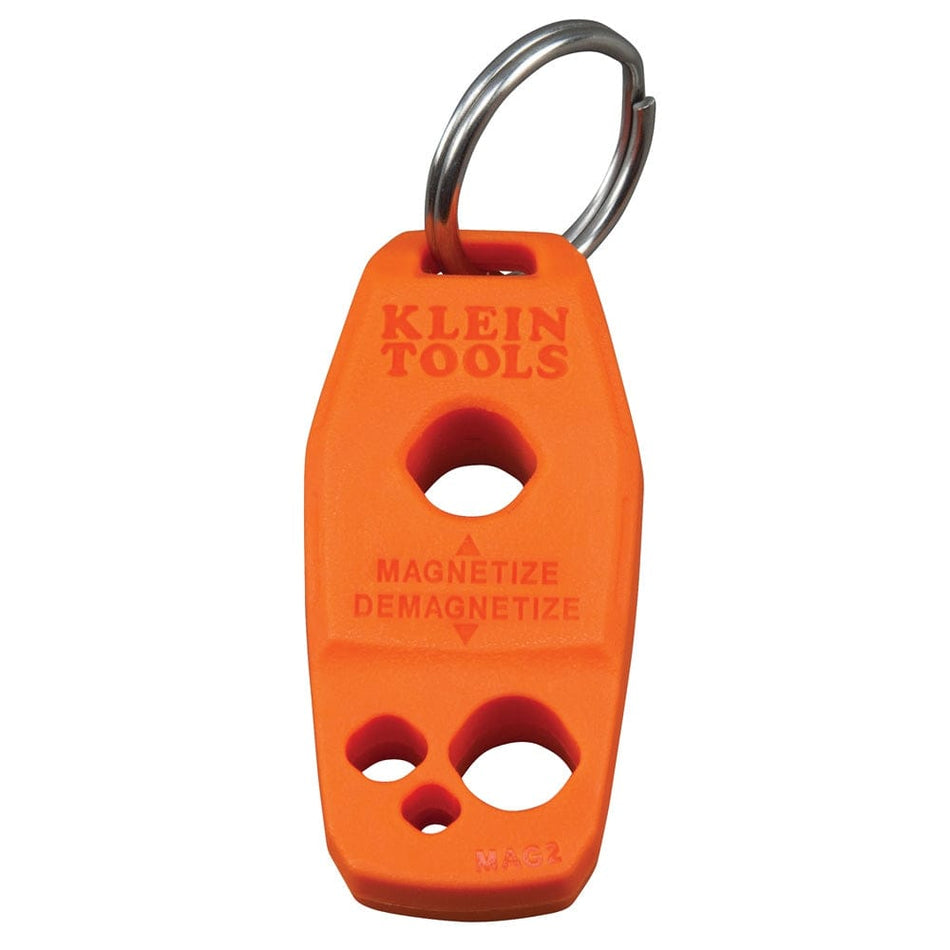 A direct front view of the orange Klein Tools MAG2 magnetizer/demagnetizer tool featuring a central magnetization hole, a smaller demagnetization hole, and a silver stainless steel key ring attached to the top.