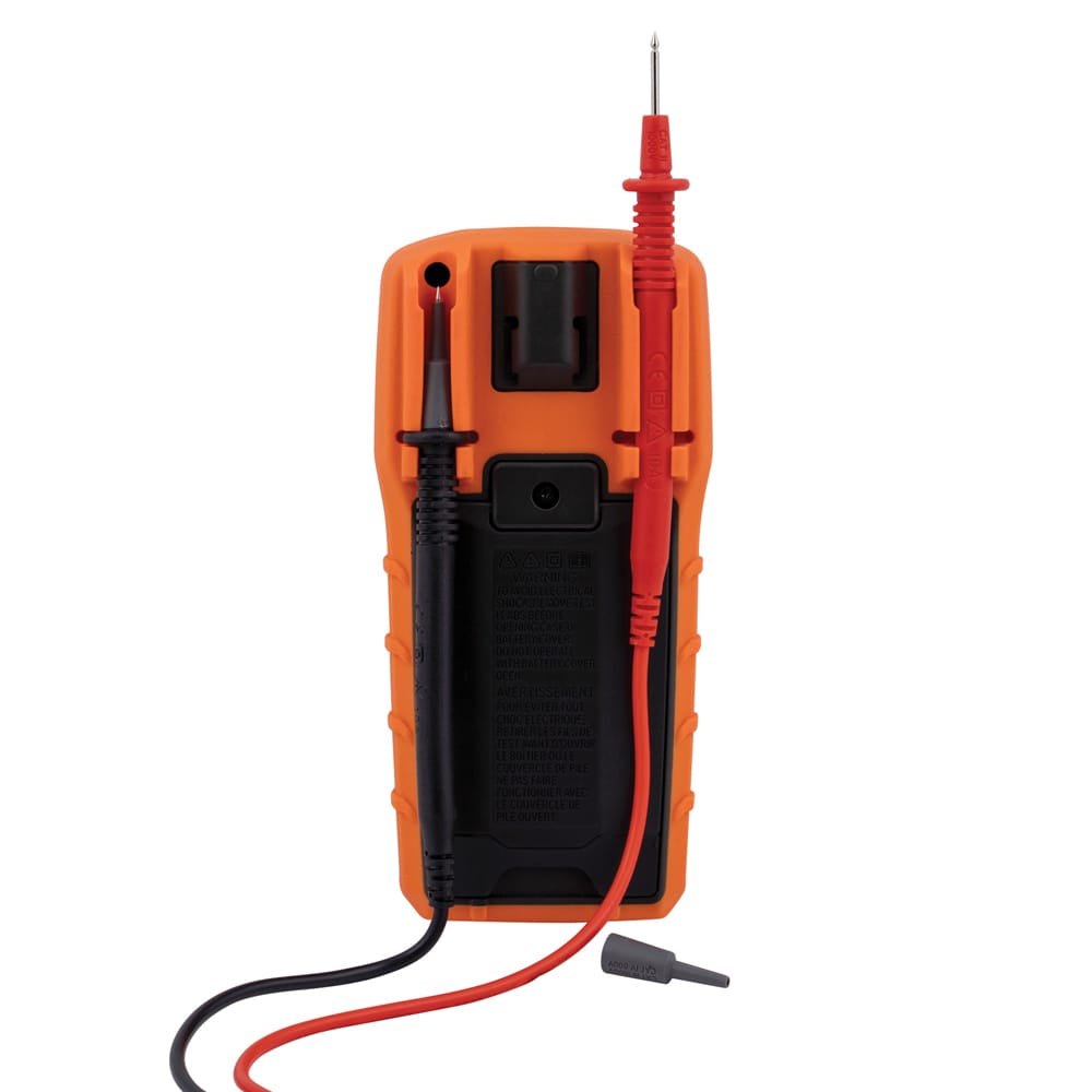 Back view of the multimeter with one black and one red test lead securely clipped into the rear storage slots, showing how the device stays organized when not in use.