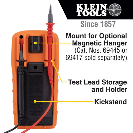 The back view of the MM720 digital multimeter highlighting its ergonomic jobsite features. The image showcases the built-in kickstand for hands-free viewing, integrated test lead storage holders, and the mount for an optional magnetic hanger for versatile positioning during electrical maintenance.