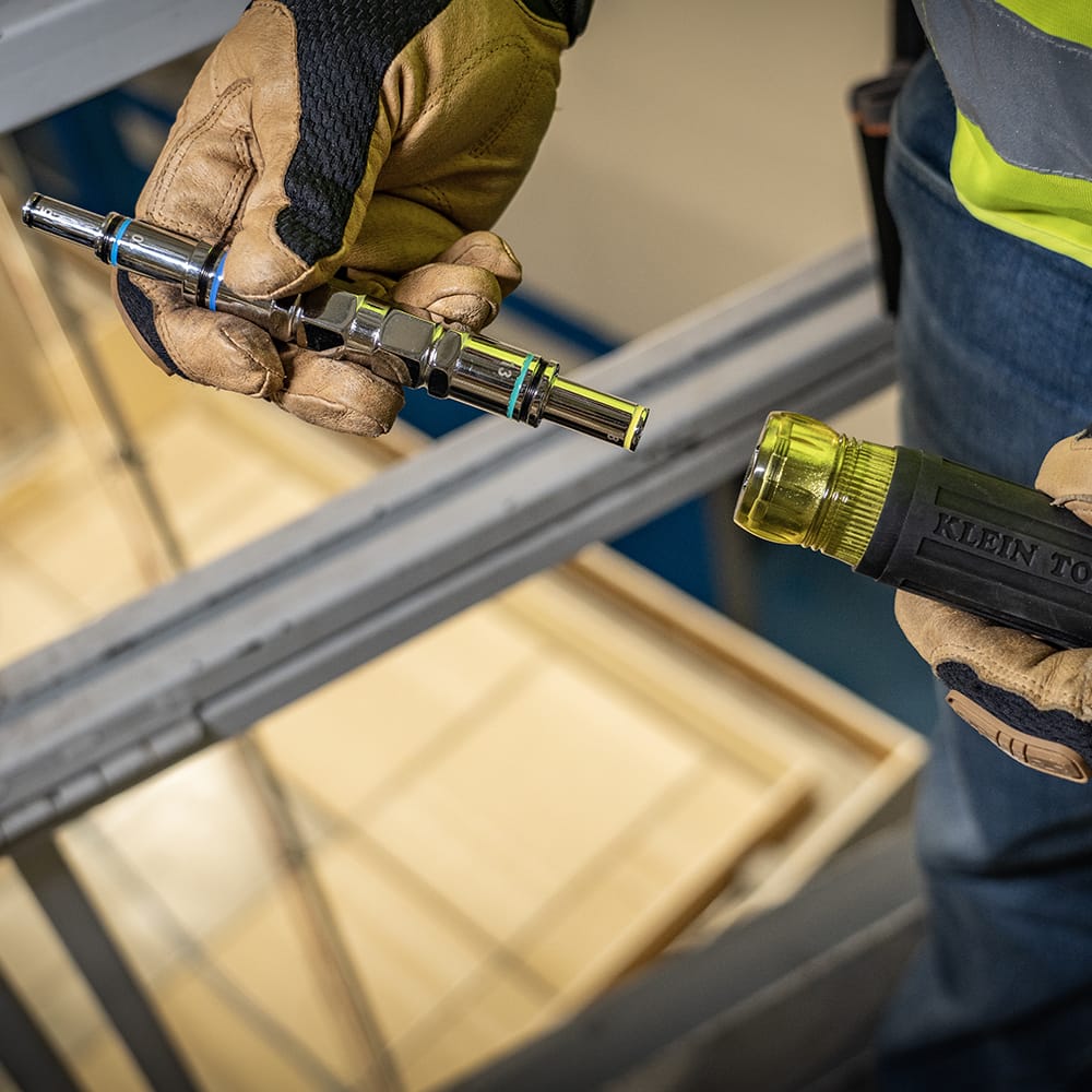 Technician removing the nested metric barrel assembly from the Cushion-Grip handle to swap drive sizes on the jobsite.