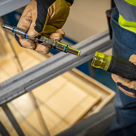 Technician removing the nested metric barrel assembly from the Cushion-Grip handle to swap drive sizes on the jobsite.