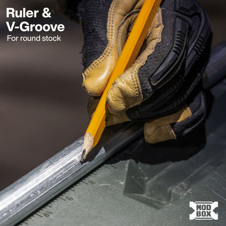 Integrated lid ruler and V-groove channel on the Klein MODbox hold conduit and pipe securely for measuring and cutting.