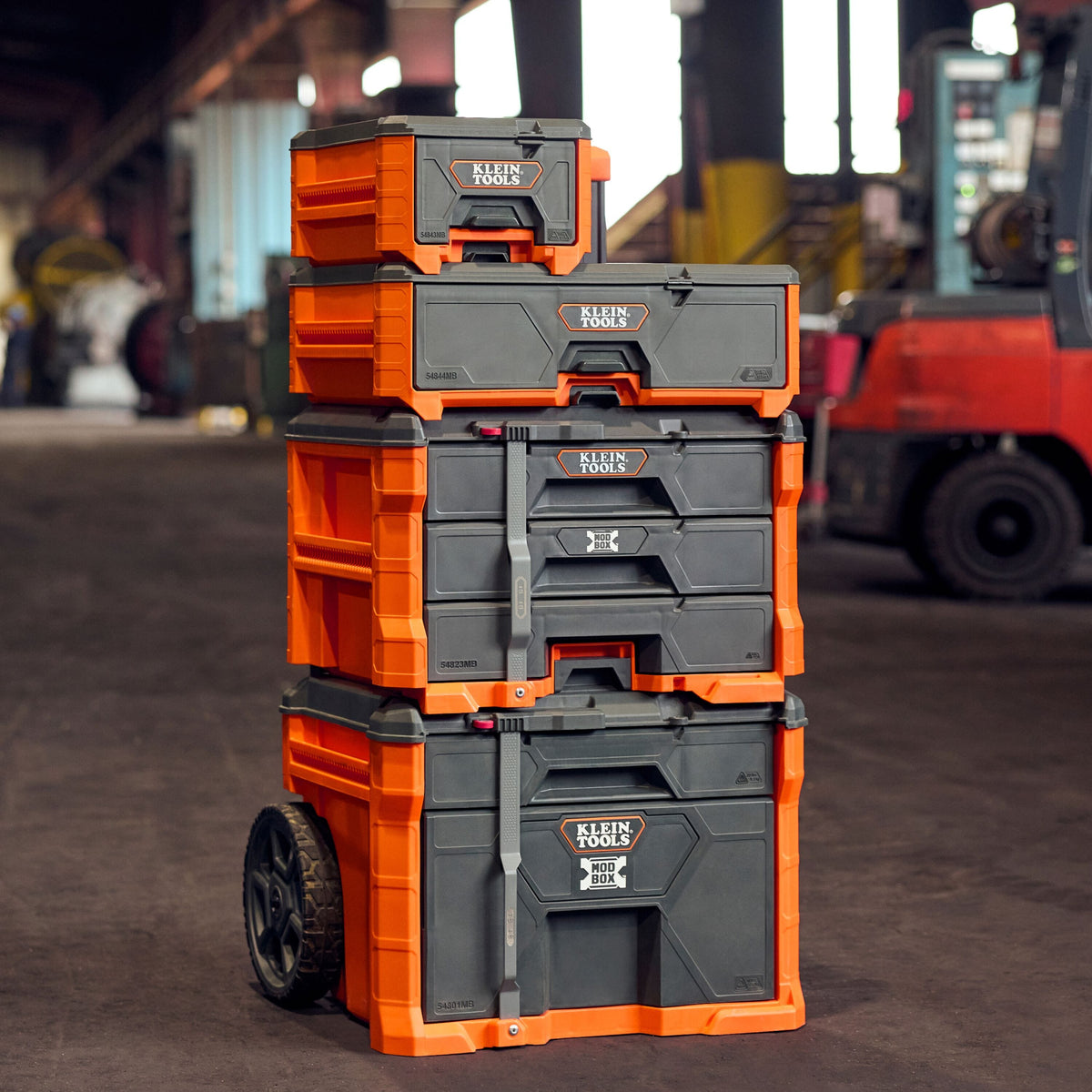 Fully stacked Klein Tools MODbox modular storage system on a jobsite provides front-drawer access without unstacking.