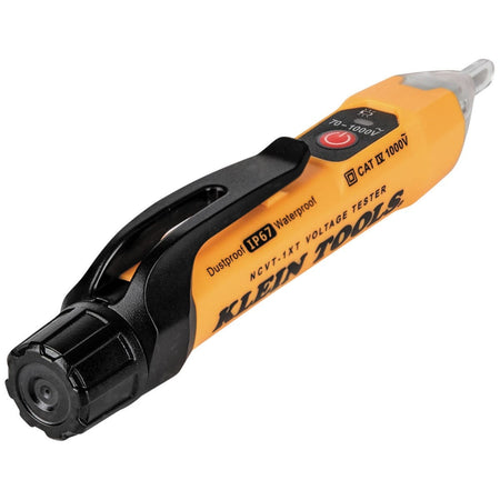 An angled perspective view of the NCVT-1XT voltage tester. The image showcases the heavy-duty polymer body, the red power-on button, and the industrial "Tough Meter" design that includes a sealed battery compartment for IP67-rated protection against the elements.