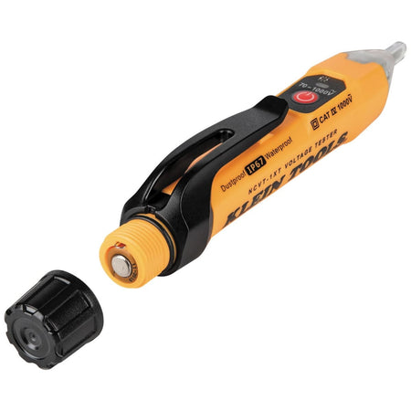 The Klein Tools NCVT-1XT voltage tester shown with its black screw-thread battery cap removed, illustrating the accessible compartment for two AAA batteries and the O-ring seal that provides waterproof and dustproof integrity.